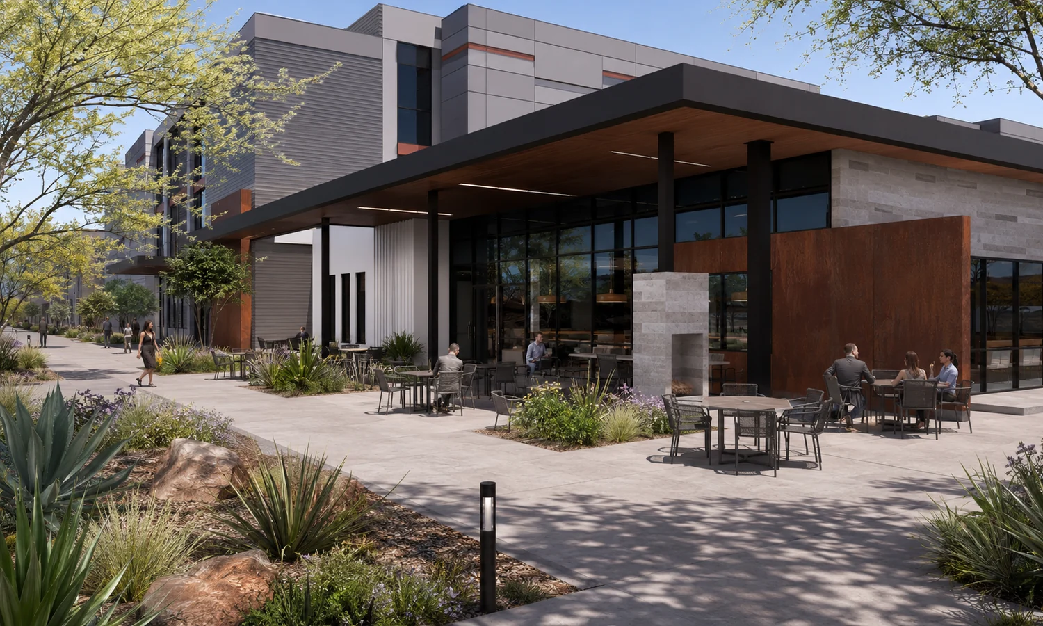 The cafe and amenity building. On-site dining and gathering space serving the campus tenant base, with a Class A building beyond.
