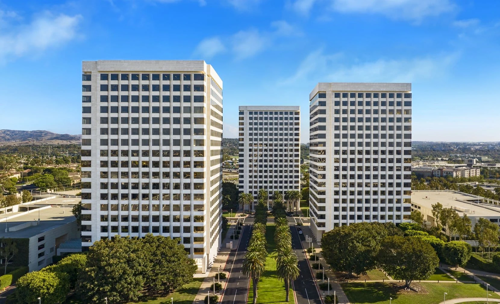 Irvine Plaza viewed from the air. The Class A towers and palm-lined boulevard at the center of Orange County’s office market.