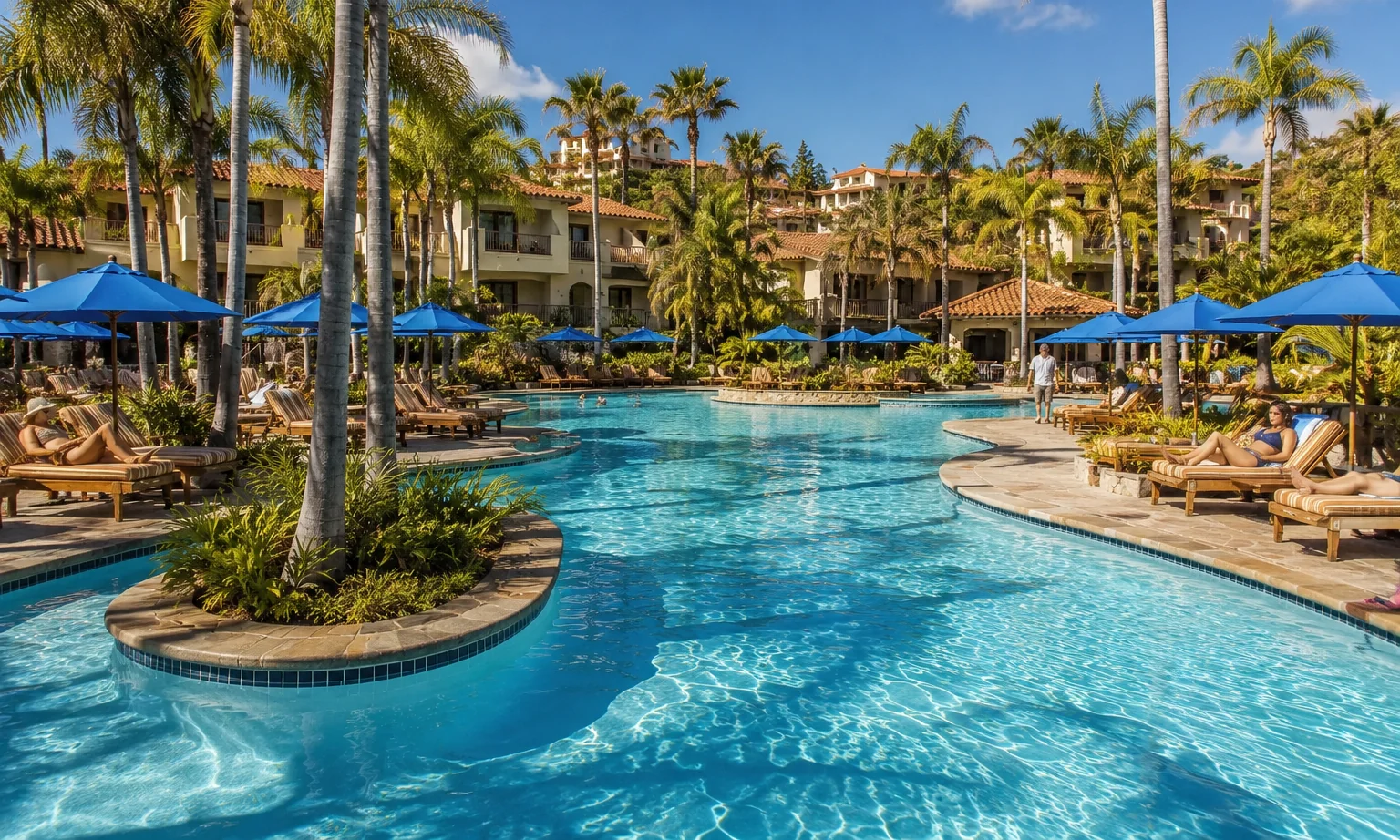 Four Seasons Aviara Carlsbad. The free-form resort pool framed by palms and Spanish Colonial villas. Branded luxury resort hospitality.