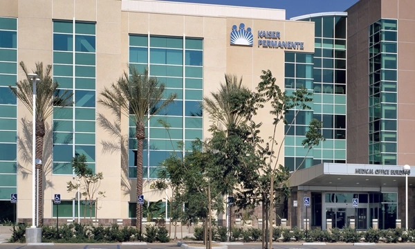 The Kaiser Permanente medical office building exterior with signage and palm-lined entry drive.