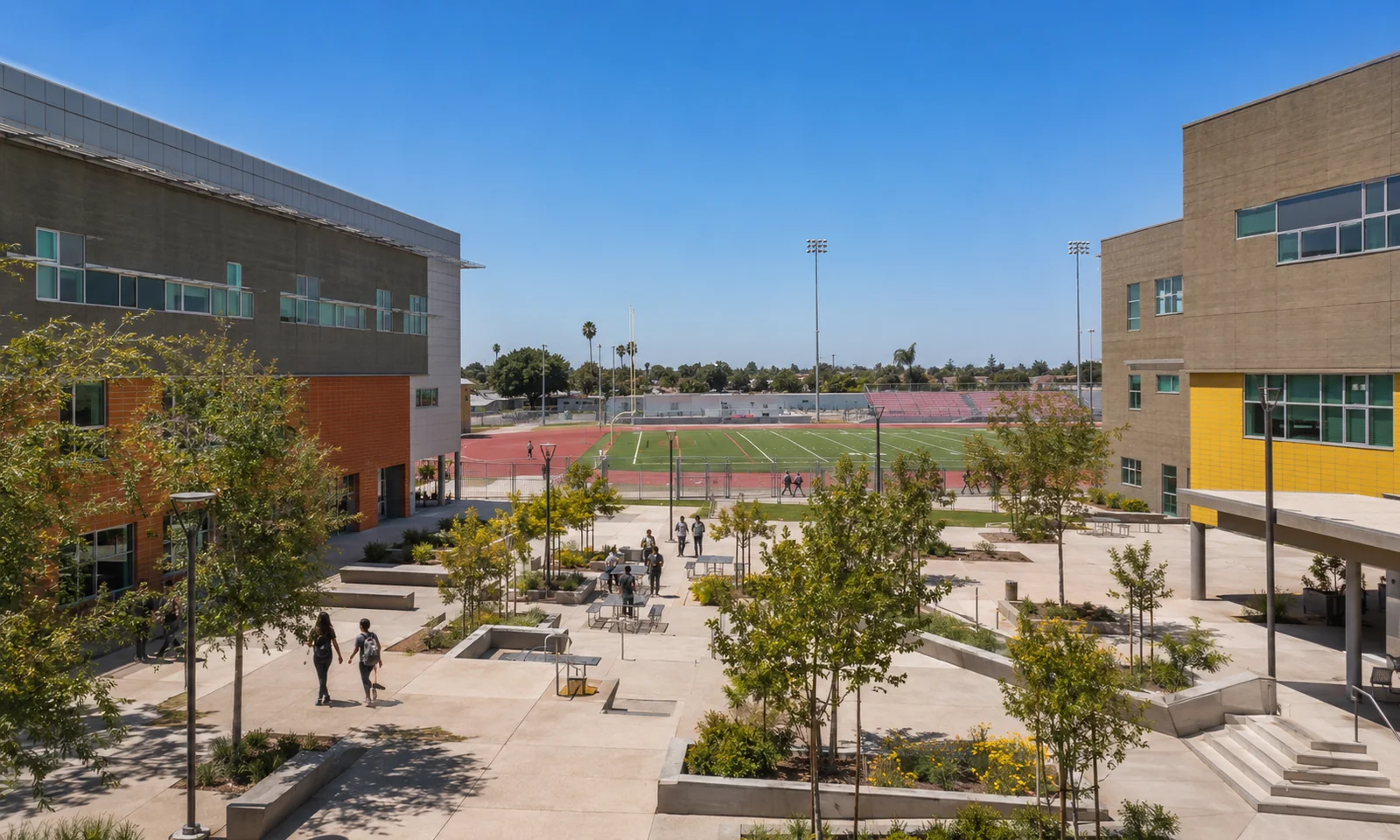 South Central Los Angeles High School No. 1. The central quad opening to the competition athletic field and running track, framed by the campus buildings. Los Angeles public-private education facility.